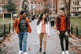 Students walking along a pathway in Autumn.