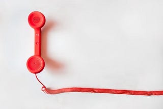 a corded red telephone