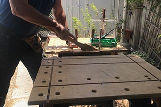 Eric using a Japanese hand saw on his workbench