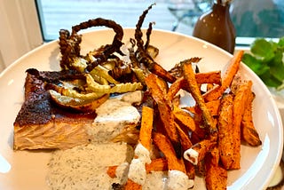 Blackened salmon with sweet potato fries & dilled Greek Goddess sauce.