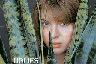 A young white girl stares at the camera from among the large leaves of a plant. “Uglies” is written in white font.