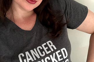 Woman striking sassy pose and wearing a “Cancer You Picked the Wrong Girl” gray and white t-shirt