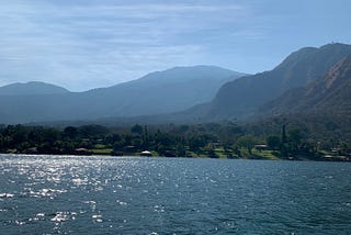 A landscape of El Salvador’s mountains resting above a lake.