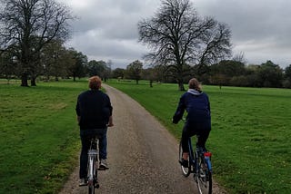 Couple biking through a park