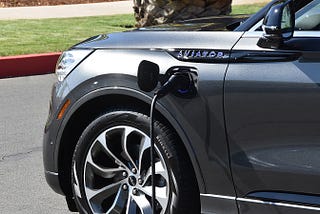 A 2020 Lincoln Aviator Grand Touring is plugged in and charging.