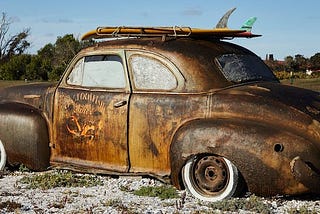 Photo of old, rusty car as a metaphor for the need to replace today’s leadership with new thinking. Politics. America. Progress. Change.