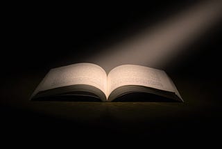 Ray of light on an open book