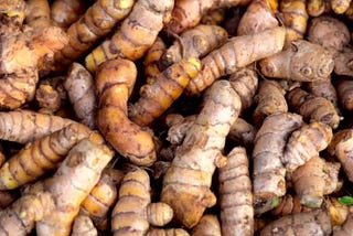 Piles of yellow and fresh turmeric root at the market display in Davao City, Philippines