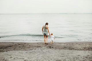 Woman and child on a sandy beach