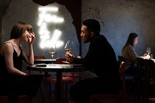 A couple having a glass of wine in a restaurant.
