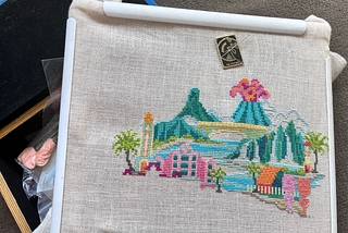 A photo of Pretty Little Hawaii Pattern by Satsuma Street cross stitch that’s half-finished.