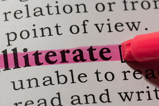 Pen highlighting the word “illiterate”