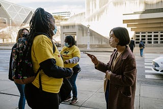 Photo of Celisa Calacal interviewing someone for a story in downtown Kansas City, Missouri.