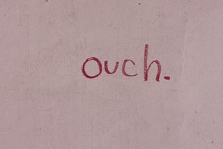 Writing on the wall that says ouch.