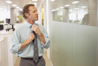 Man adjusting his tie.