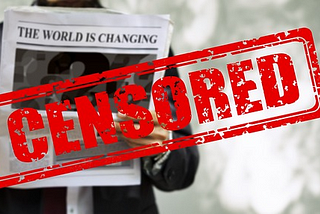 Man holding newspaper with “Censored” in red letters