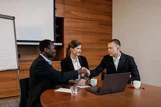 Professionals siting in an office choosing and making deals