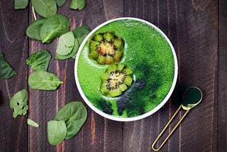 Green Smoothies made with spinach, spirulina, almond milk and kiwi