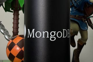 Zoomed-in shot of a MongoDB Camelbak water bottle, flanked on the left by a Dr. Robotnik figure and on the right by a Link figure from Breath of the Wild.