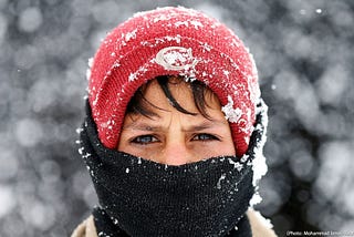 Displaced boy during a snowfall in Kabul