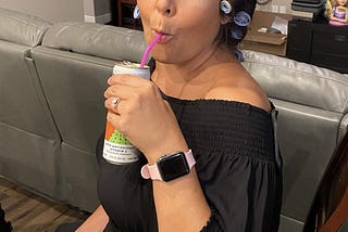 Photo of the author with her hair in curlers sipping a beverage about to talk tea.