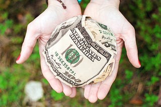 Person holding dollars in their hands