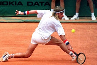 Björn Borg stretches to play a shot on the red clay at Monte Carlo in 1991.