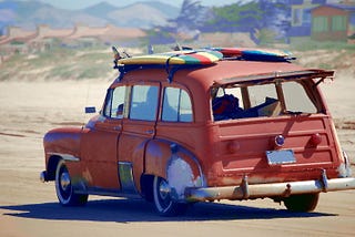 An old jalopy that is carrying surf boards to the beach even after all these years.