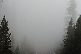 empty road shrouded in fog