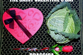 A red heart-shaped box with diagonal black ribbon and bow on the left of a savoy cabbage. An artificial rose is directly below.