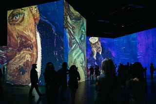 Vincent van Gogh exhibit with silhouettes of people onserving