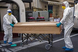 Medical staff with coffin of Assunta Pastore, 87, who died in NW Italy. Photo: AP