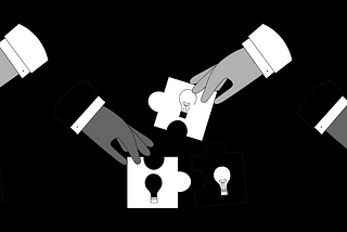 Hands fixing jigsaw puzzles with images of light bulbs on them together