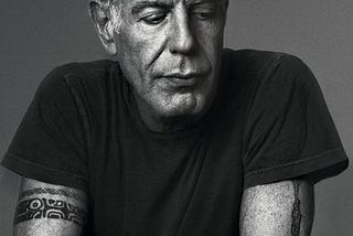 A black and white portrait of Anthony Bourdain