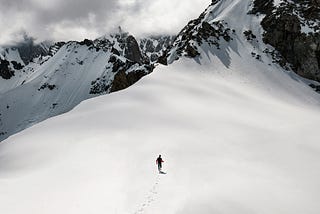 Man running in a wide snow mountain