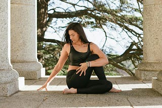 Attractive woman doing outdoor yoga.