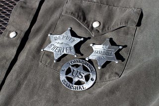 Three badges on a shirt