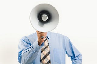 A photo of a man holding a megaphone