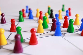 Colourful, plastic, game playing pieces arranged in a network.