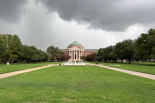 Building with copper dome on a dark, cloudy day