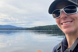 Selfie of the author paddling a kayak on a lake