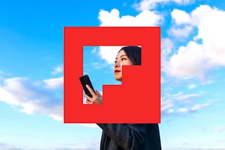 Flipboard’s logo, a red square with a transparent F, with mostly blue sky behind it. In the middle is a woman holding a phone, mostly visible through the F-shaped opening in the logo.