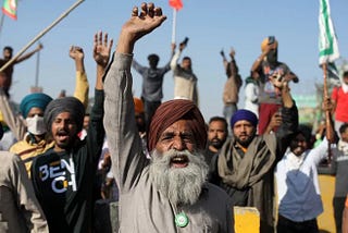 Protesting farmers shout slogans as they clash with police while attempting to move toward Delhi