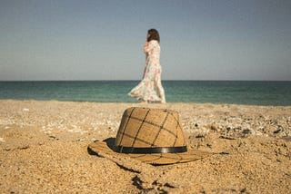 Woman and panama hat on a beach