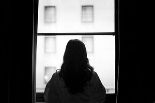 woman standing in front of a window