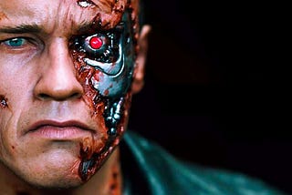 Arnold Schwarzenegger from his role in The Terminator with part of his face missing to expose a metal skeleton with menacing red eye