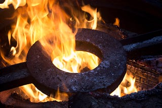 Photo of iron ring in a forge with fire.