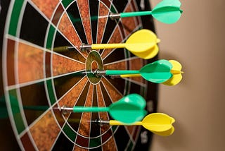 A dart board filled with darts, symbolic of the many jabs and snipes at a generation