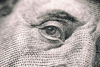 close up view of eye on money
