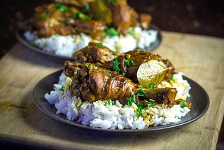 Image of chicken adobo over white rice, a traditional (pre-colonial) Philippine dish